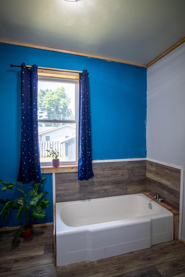 bathroom featuring wood-type flooring and a bathing tub