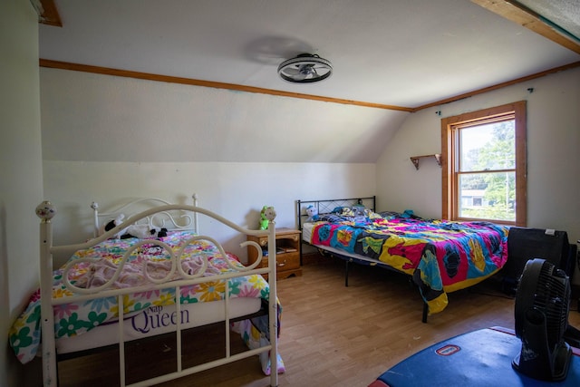 bedroom featuring hardwood / wood-style flooring and lofted ceiling