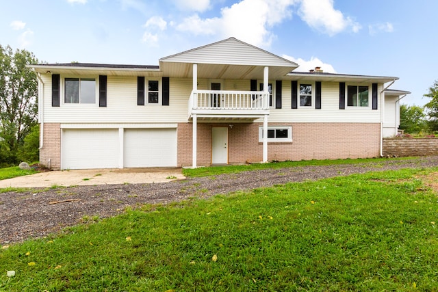 view of front of house with a garage and a front lawn