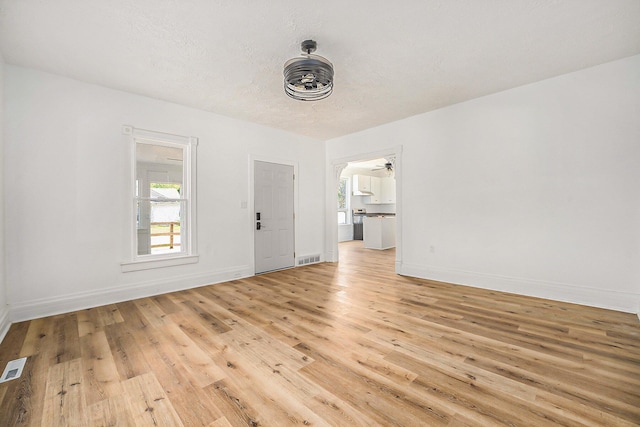 unfurnished room featuring ceiling fan and light wood-type flooring