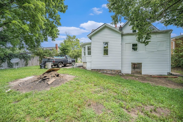 back of house featuring a yard