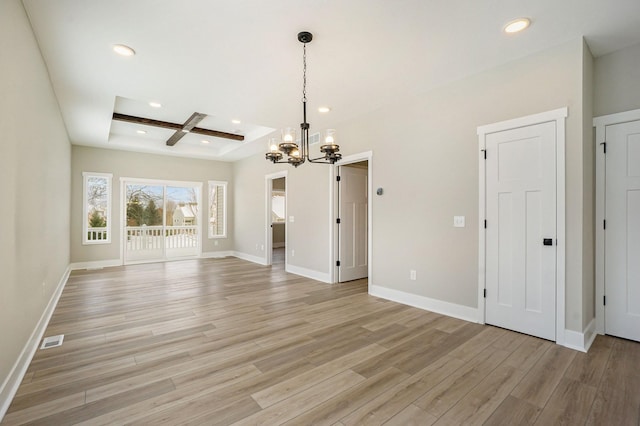 unfurnished living room featuring coffered ceiling, light hardwood / wood-style flooring, a tray ceiling, a notable chandelier, and beam ceiling