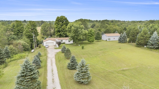 birds eye view of property with a view of trees