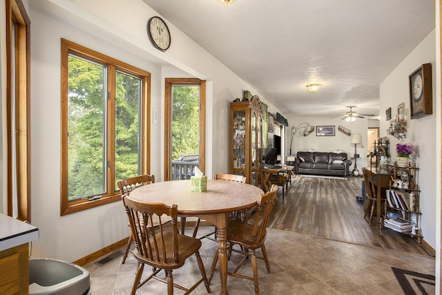 dining area featuring visible vents, a ceiling fan, and baseboards