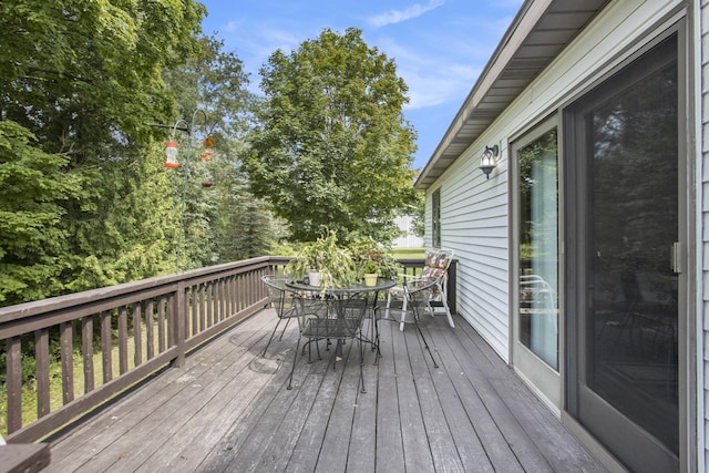 wooden deck featuring outdoor dining area