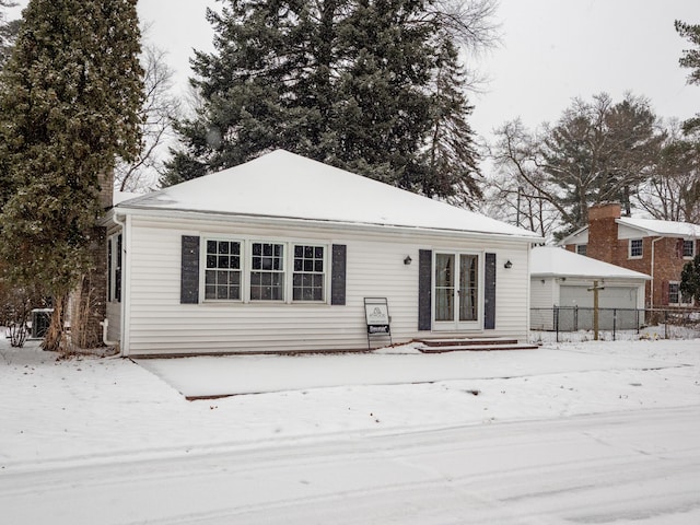 view of snow covered back of property