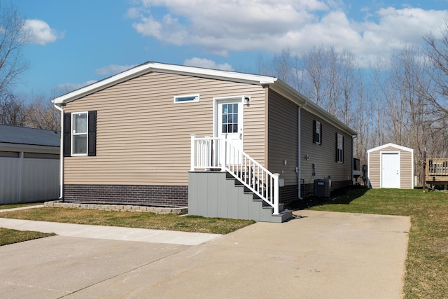 view of home's exterior with a lawn, a patio area, a shed, and central air condition unit