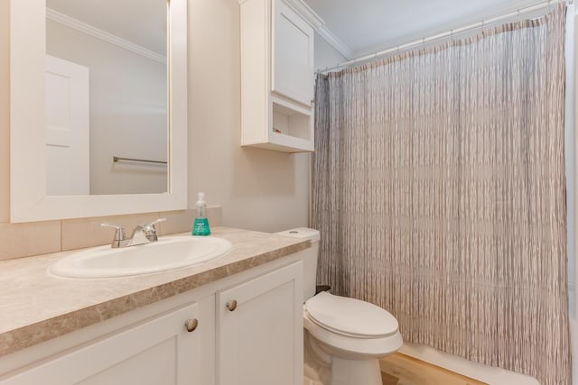 bathroom with vanity, curtained shower, ornamental molding, and toilet