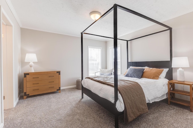 bedroom with ornamental molding, a textured ceiling, and carpet flooring