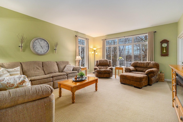 living room with baseboards and light colored carpet