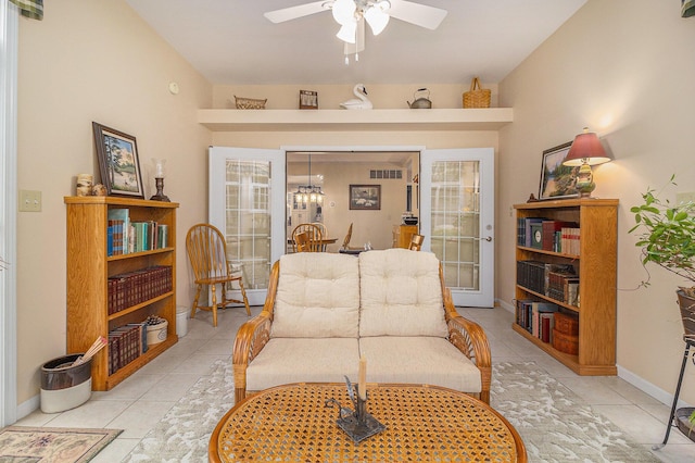 living area with french doors, light tile patterned flooring, ceiling fan, and baseboards