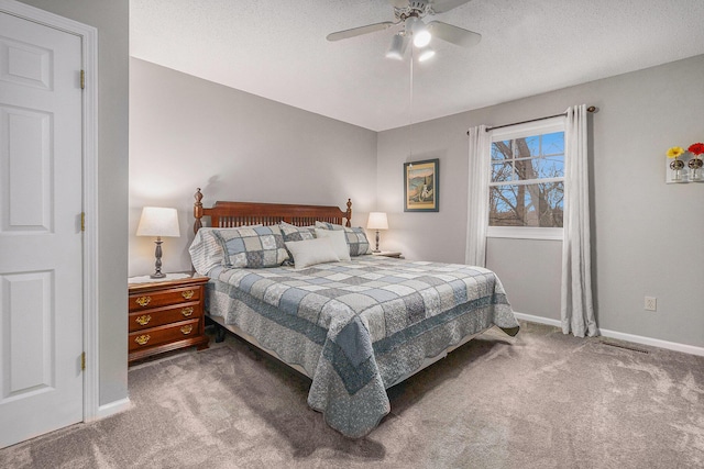 carpeted bedroom featuring a textured ceiling, ceiling fan, and baseboards