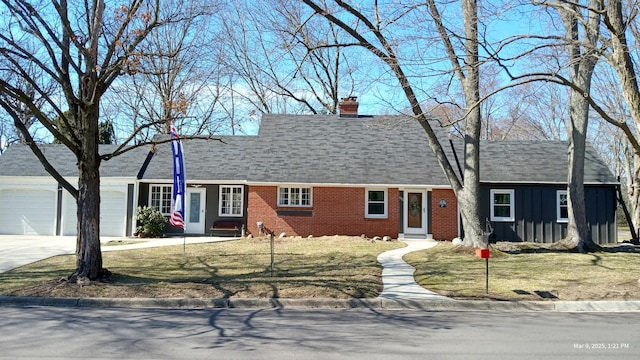 view of front facade featuring brick siding, a chimney, an attached garage, board and batten siding, and driveway