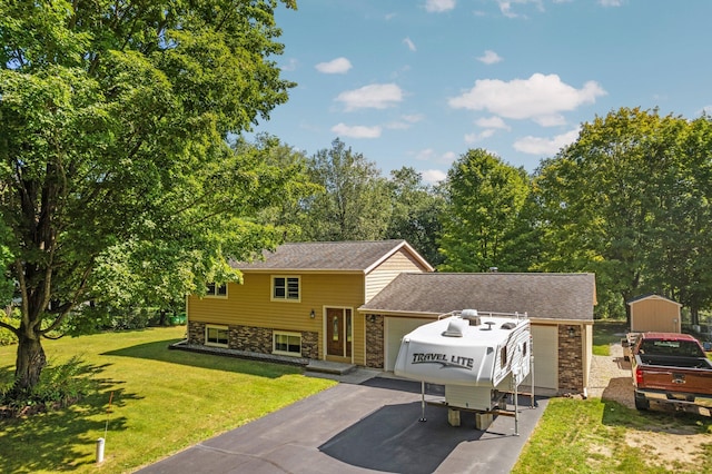 bi-level home featuring a storage unit and a front lawn