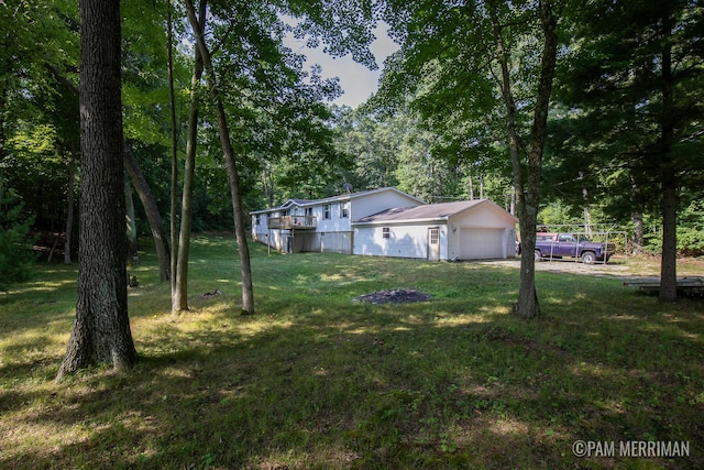 view of front of property with a garage and a front lawn