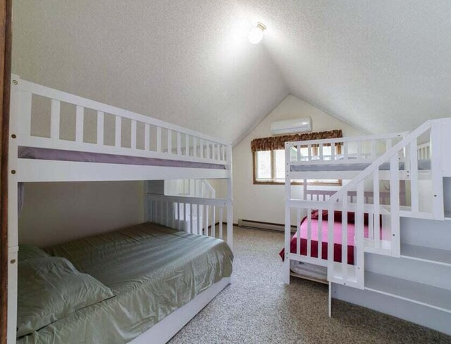 bedroom featuring a baseboard heating unit, a textured ceiling, carpet floors, lofted ceiling, and an AC wall unit