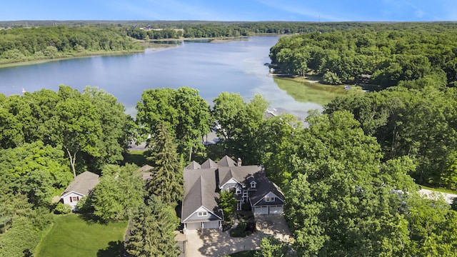 drone / aerial view featuring a forest view and a water view