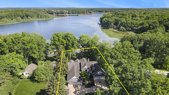 aerial view with a wooded view and a water view