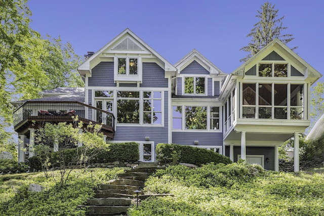 back of property with a sunroom