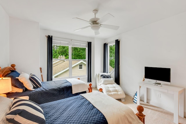 carpeted bedroom featuring baseboards and ceiling fan