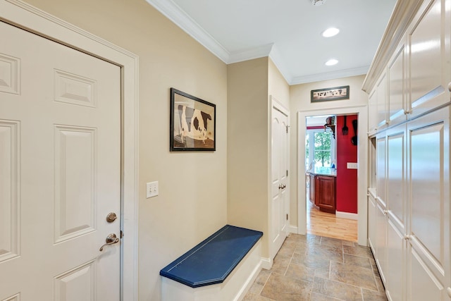 entryway with crown molding, recessed lighting, baseboards, and stone tile flooring