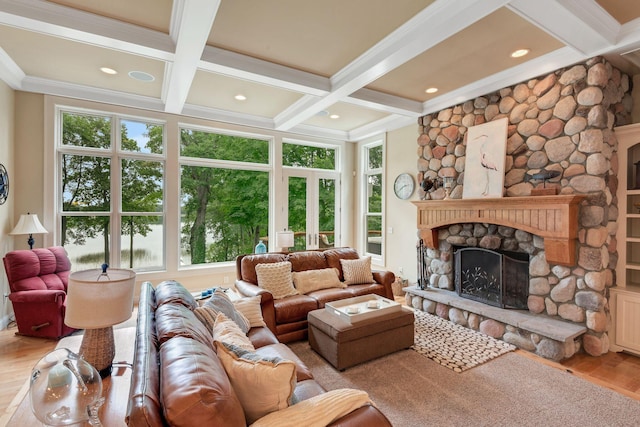 living room featuring beamed ceiling, coffered ceiling, wood finished floors, a fireplace, and crown molding