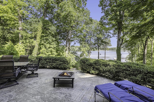 view of patio / terrace with outdoor dining area and an outdoor fire pit