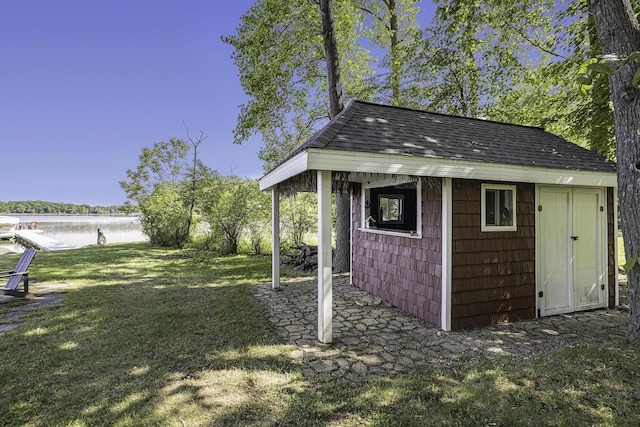 view of outbuilding with an outdoor structure and a water view