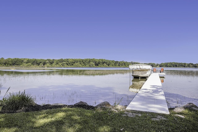 dock area with a view of trees and a water view