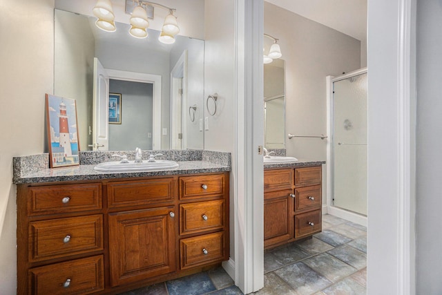 full bathroom with a sink, two vanities, and a shower stall