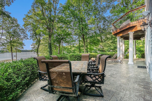 view of patio / terrace with outdoor dining area and a water view