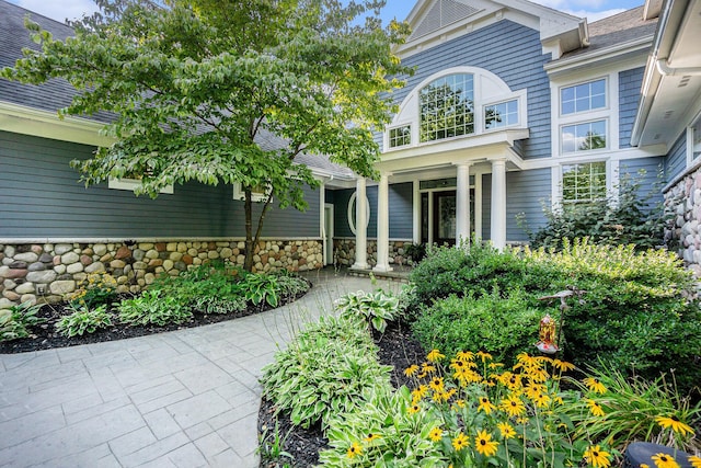 entrance to property featuring stone siding