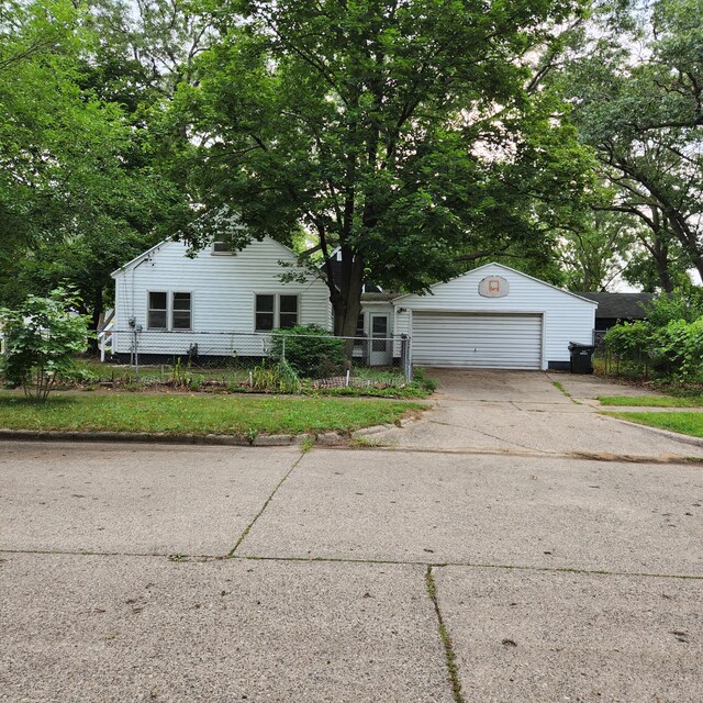 view of front of property featuring a garage and an outbuilding