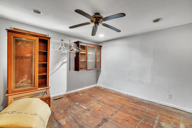 unfurnished bedroom with ceiling fan and hardwood / wood-style floors