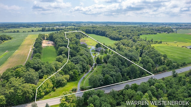 birds eye view of property with a rural view