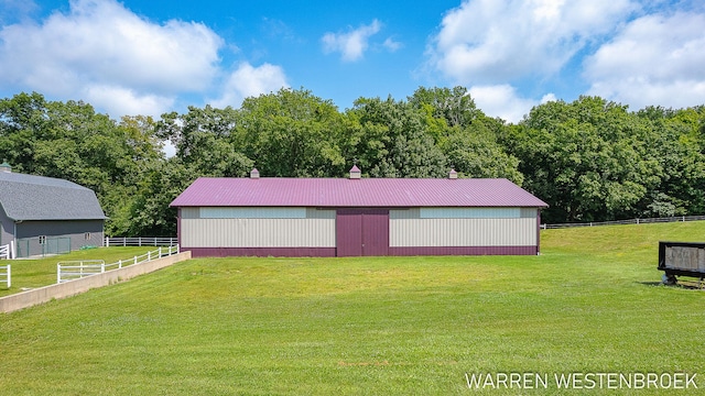 view of outbuilding featuring a lawn