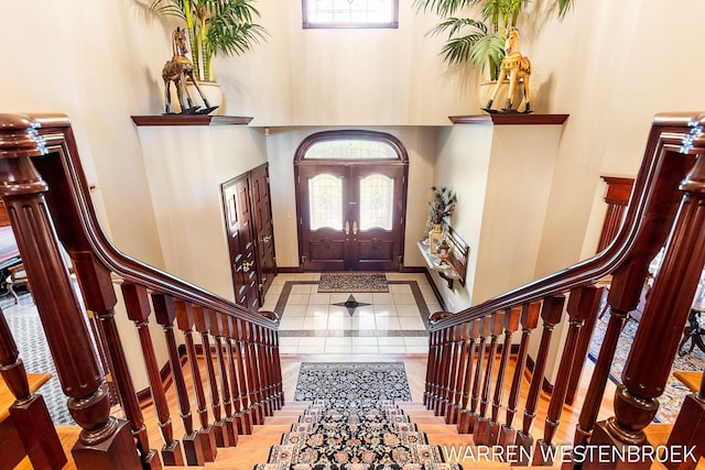 tiled foyer with a high ceiling