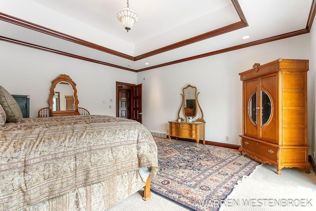 bedroom with ornamental molding, a tray ceiling, and carpet floors