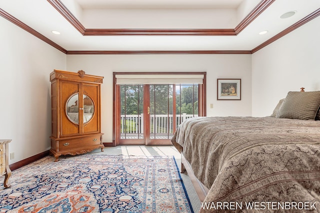 bedroom with a raised ceiling, ornamental molding, and access to exterior