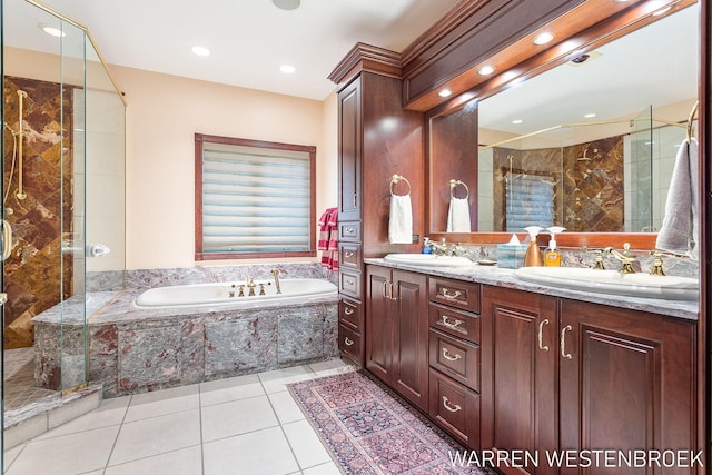 bathroom with shower with separate bathtub, vanity, and tile patterned floors