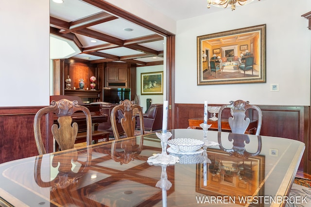 dining room featuring coffered ceiling and beam ceiling