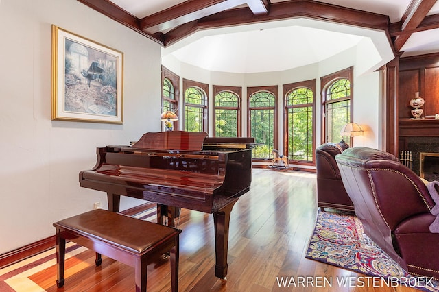 miscellaneous room with wood-type flooring and vaulted ceiling with beams