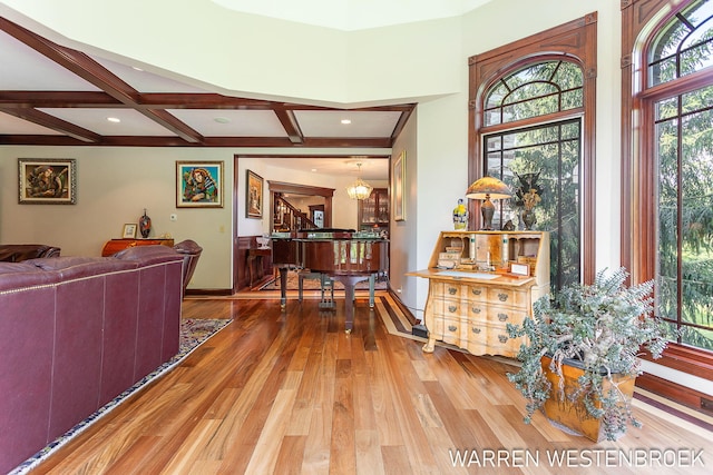 living room with wood-type flooring, coffered ceiling, and beam ceiling