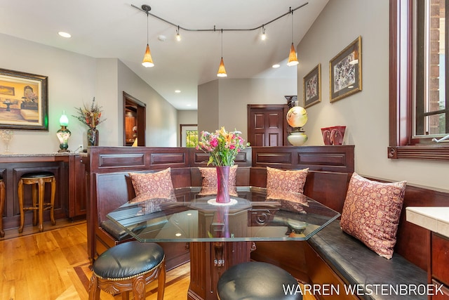 dining room with track lighting and light hardwood / wood-style flooring