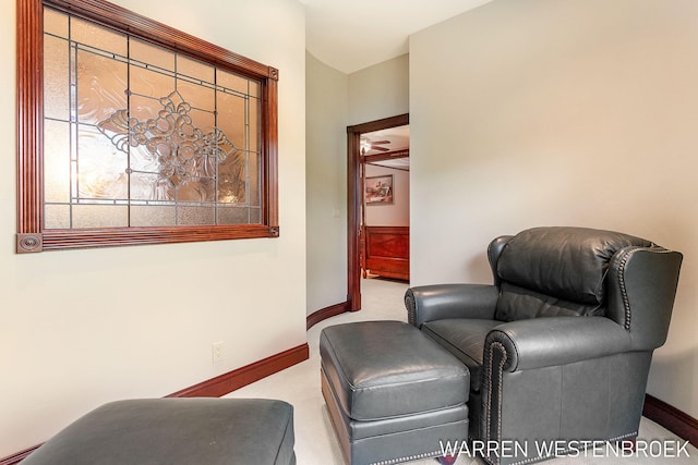 living area featuring light carpet