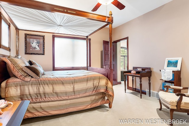 bedroom with light carpet, lofted ceiling, and ceiling fan