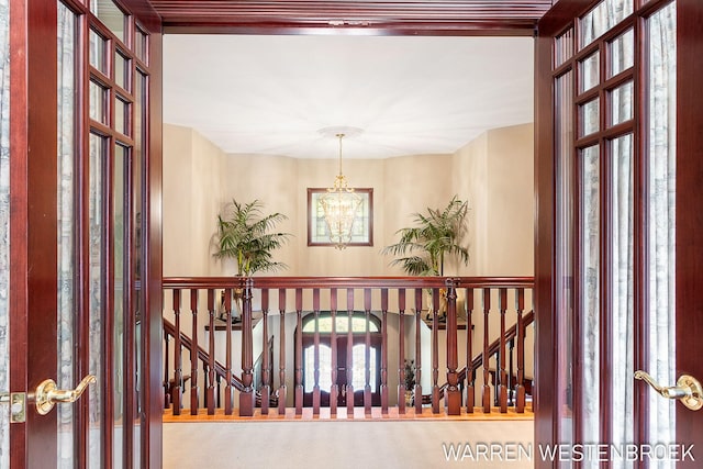 hallway with a notable chandelier