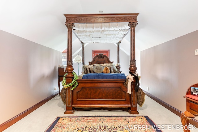 carpeted bedroom with vaulted ceiling