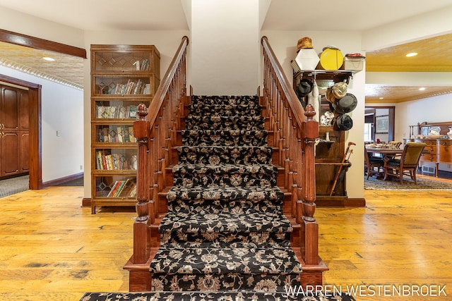 stairs featuring hardwood / wood-style flooring