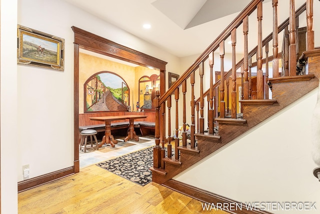 staircase with hardwood / wood-style floors